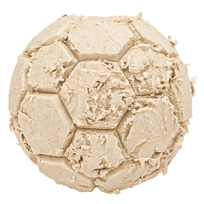 Light wear on a D-Bone Ball dog chew after regular chewing: the facets are still readable and small flakes lift along the seams.