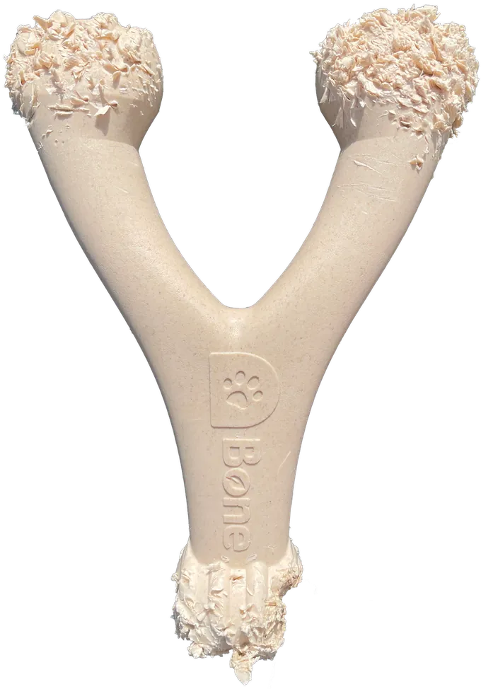 Heavy wear on a D-Bone Wishbone dog chew: both ends and the base are covered in thick clusters of flakes.